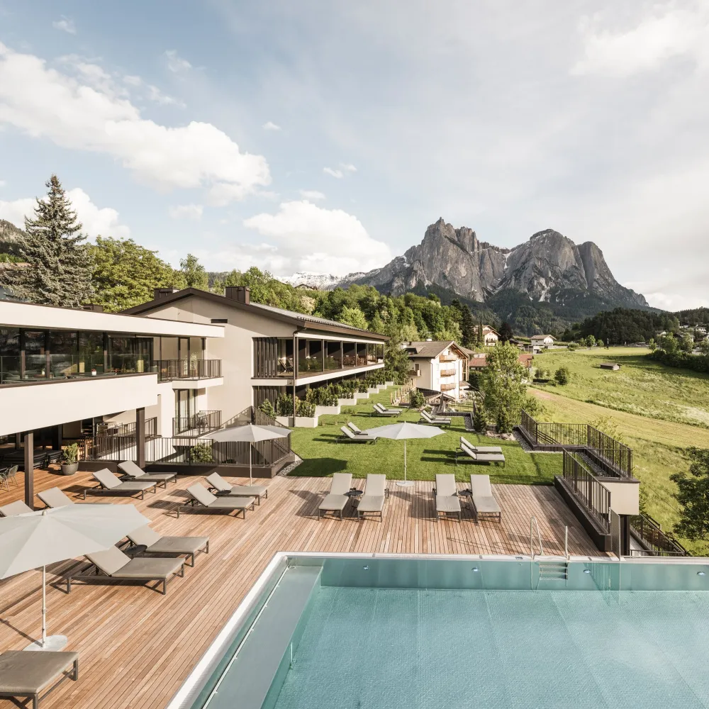 Wellness Hotel Alpenflora in Castelrotto with infinity pool and sun terrace before the Dolomites
