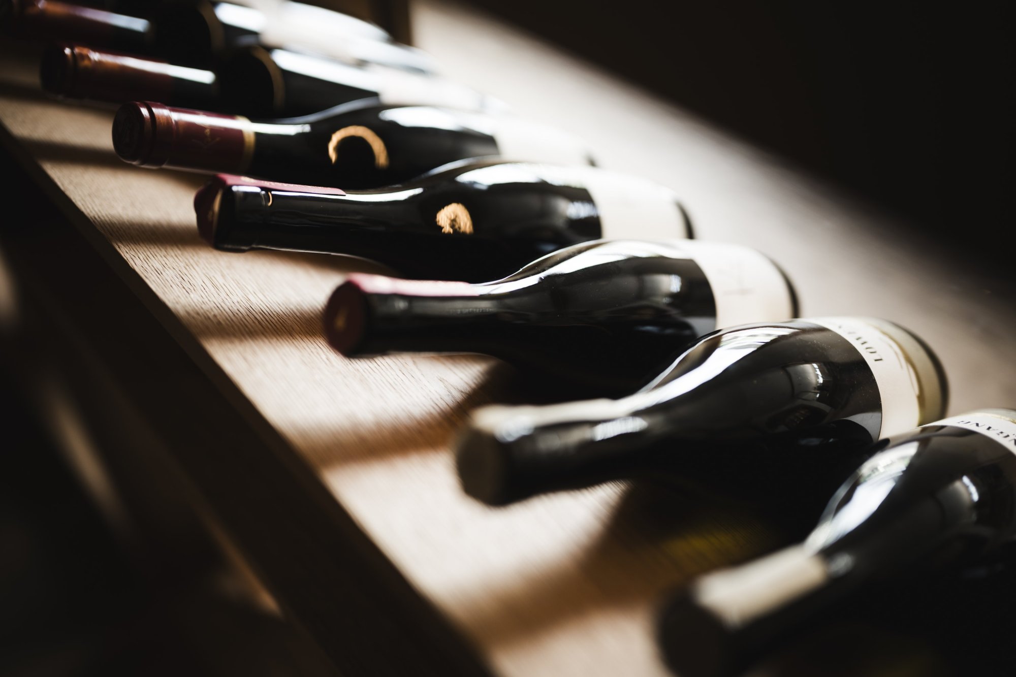 Wine bottles lying in a row in the wine cellar of the Wellness Hotel Alpenflora