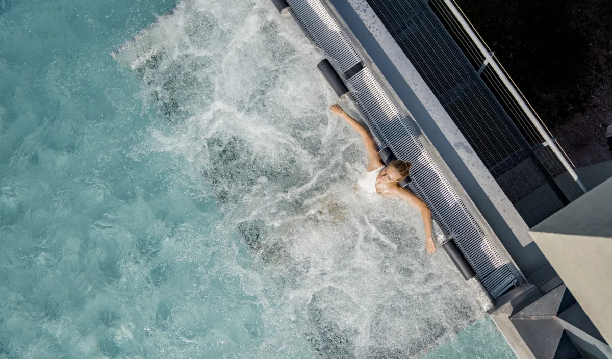 Infinity pool at the Alpenflora seen from above with clear water edge in Castelrotto